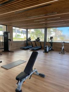 een fitnessruimte met diverse loopbanden en hometrainers bij Luxury apartment in Flamenca Village/Orihuela Costa in Orihuela-Costa