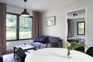 a living room with a couch and a table at Naantali City Apartments in Naantali