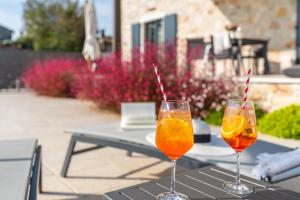 two wine glasses sitting on top of a table at Villa Hizina Veleniki in Poreč