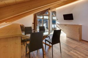 a dining room with a table and chairs at Olympic Chalet 13 in Bormio