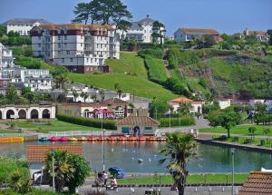 a town with a lake in front of a city at Two Beaches in Paignton