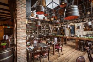 a restaurant with tables and chairs in a room at 4-Sterne Erlebnishotel El Andaluz, Europa-Park Erlebnis-Resort in Rust