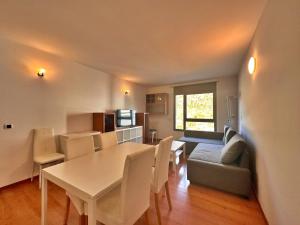 a dining room and living room with a table and chairs at Tucamp 3,8 Al lado del telecabina para 6 pax in Encamp