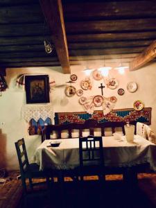 a dining room with a table and plates on the wall at Casa din deal in Baia-Sprie