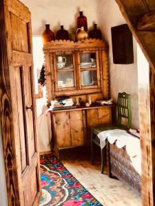 Zimmer mit einem Schrank, einem Tisch und einem Stuhl in der Unterkunft Casa din deal in Baia Sprie