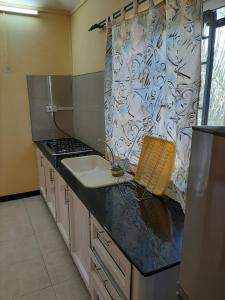 a kitchen with a sink and a counter top at DINO 2 in Trou aux Biches