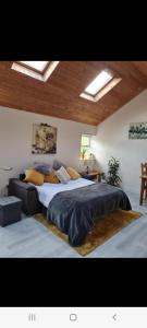 a large bedroom with a large bed with pillows at Tranquil Water in Midleton