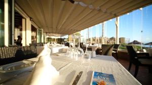 a table with a white table cloth and a book on it at Marbella Beach Resort at Club Playa Real in Marbella