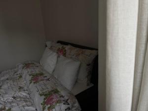 a bedroom with a bed with pillows and avertisement at Riga RiverPark - One-Bedroom Apartment Near Downtown in Rīga