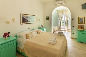 a bedroom with a bed with two towels on it at Hotel Ossidiana Stromboli Center in Stromboli