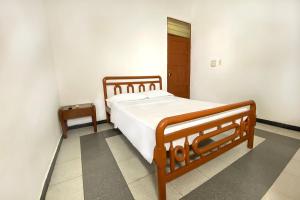 Ένα ή περισσότερα κρεβάτια σε δωμάτιο στο Hotel Ayenda Republicano Colonial No 2 +22 φωτογραφίες