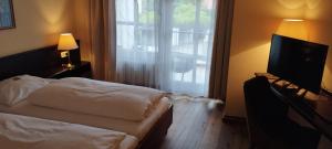 Postel nebo postele na pokoji v ubytování Hotel am Theater