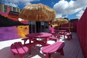 a group of picnic tables and umbrellas on a deck at Penthouse Apartment, Sleeps 21 with terrace in Liverpool