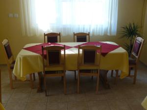 a dining room table and chairs with a yellow and red table cloth at House Arirang in Cherni Osŭm