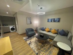 a living room with a couch and a table at BN Residence بي ان ريزدنس للشقق المخدومه in Al Khobar