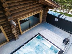 an overhead view of a swimming pool next to a house at Wellness Hotel Alpenhof in Zermatt