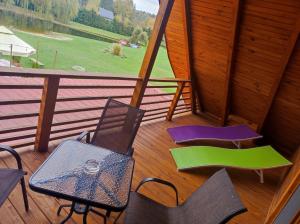 a room with chairs and a table on a porch at Dworek Dąbrowa in Tomaszów Lubelski