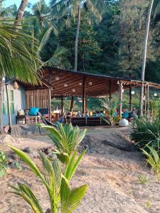 a resort with a pavilion on the beach at Bamboo Yoga Retreat in Canacona