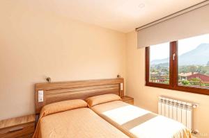 A bed or beds in a room at Apartamento 4 personas en la naturaleza Bisonte
