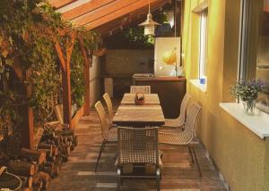 a wooden table and chairs on a patio at Bella Garden in Balatonszárszó