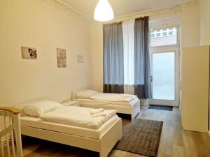 two beds in a room with a window at Luxury 4-rooms apartment in Berlin Z in Berlin