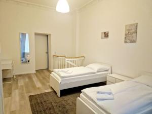 a bedroom with two beds and a desk in it at Luxury 4-rooms apartment in Berlin Z in Berlin