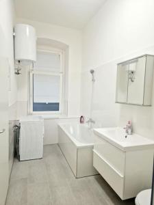 a white bathroom with two sinks and a window at Luxury 4-rooms apartment in Berlin Z in Berlin