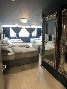 a bedroom with two beds and a large mirror at Unique city centre DJ apartment - sleeps 20 in Liverpool