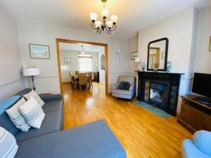 a living room with a couch and a fireplace at Chiswell Cottage a large family nr WPNSA & Beach in Castletown