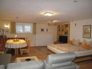 ein Zimmer mit einem Bett, einem Tisch und einer Couch in der Unterkunft Haus Anna in Beaumarais