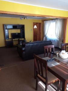 a living room with a couch and a table at HOWENH in Porvenir