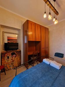 a bedroom with a blue bed and a desk at Borgo Vittoria House in Turin
