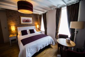 a hotel room with a bed and a window at The Grove in St. Davids