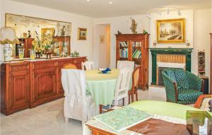 a living room with a table and chairs at 4 Bedroom Lovely Home In Langueux in Langueux