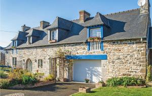 a stone house with a garage in front of it at 4 Bedroom Lovely Home In Langueux in Langueux