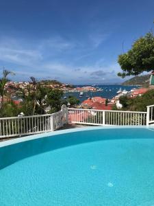 a swimming pool with a view of the ocean at Viewstar in Gustavia