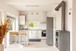 a kitchen with white cabinets and a stove at Hillhouse Novo mesto in Novo Mesto