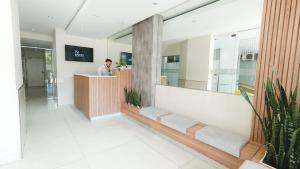 a man standing at a reception desk in a lobby at Isi Baires Alquiler Temporario in Buenos Aires