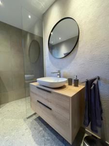 a bathroom with a sink and a mirror at Apartment Aliprandi in See