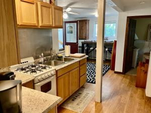 a kitchen with a sink and a stove top oven at Clear Pond Getaway in Plymouth