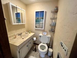 a bathroom with a toilet and a sink at Clear Pond Getaway in Plymouth