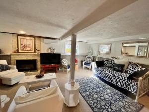 a living room with a couch and a fireplace at Clear Pond Getaway in Plymouth