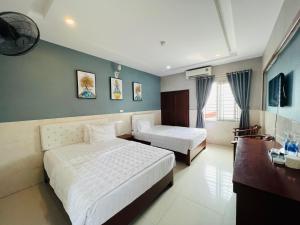 Katil atau katil-katil dalam bilik di Hoang Ngan 1 Hotel - TP. Vinh
