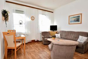 a living room with a couch and a table at Haus-Herrmann-2 in Borkum +2 photos