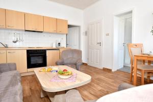 a kitchen and a living room with a table and chairs at Haus-Herrmann-2 in Borkum