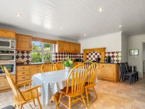 a kitchen with a table and chairs in a kitchen at Sycamore Cottage in Clifden +40 photos