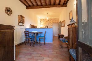 a dining room with a blue table and chairs at Gelsomina- Agriturismo La Valentina in Talamone