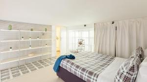 a bedroom with a bed with a plaid blanket at Trevi Fountain Loft Apartments in Rome