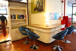 a salon with two chairs and a desk in a room at Armenian Street Heritage Hotel in George Town