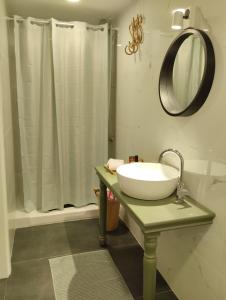 a bathroom with a sink and a shower at Enallio Luxury Apartments in Nafplio
